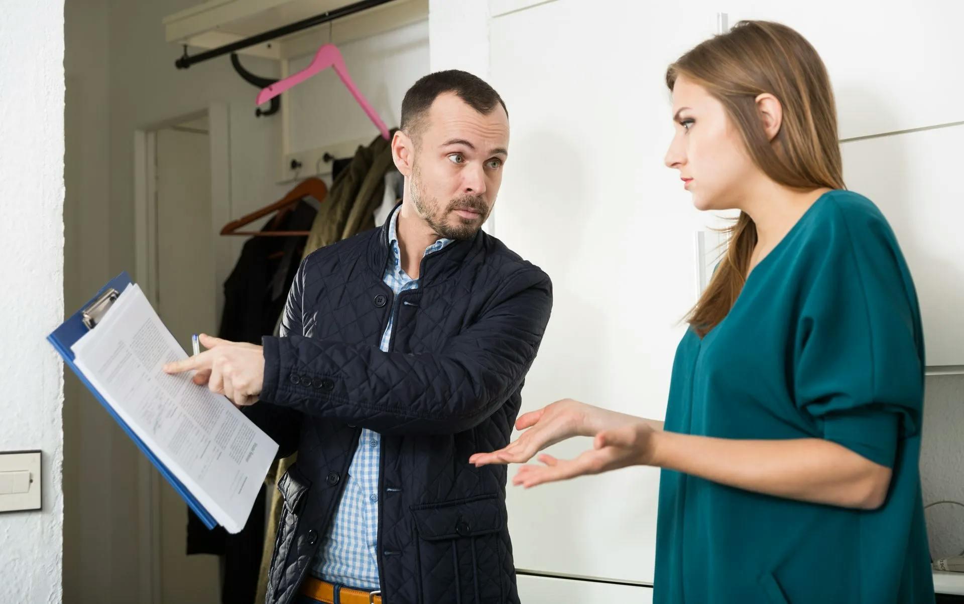 A man showing a paper to a woman